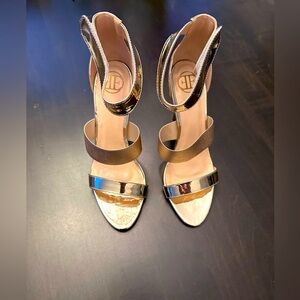 Brand new high heels. Size 8.5. Gold. Velcro adjustable strap. With box.